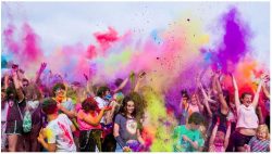 crowd of young people with colored smoke