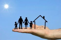 hand holding outlines of a nuclear family