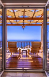 chairs facing an oceanfront balcony