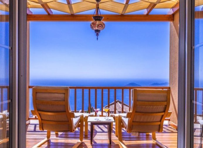 chairs facing an oceanfront balcony