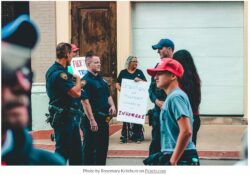 police and citizens gather near an immigration protest
