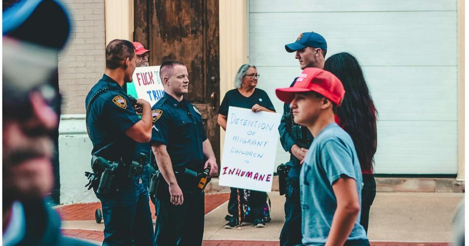 police and citizens gather near an immigration protest